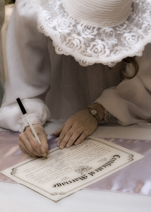 Kristina signing the marriage certificate.